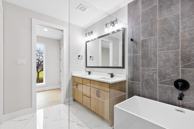 bathroom with vanity and a tub