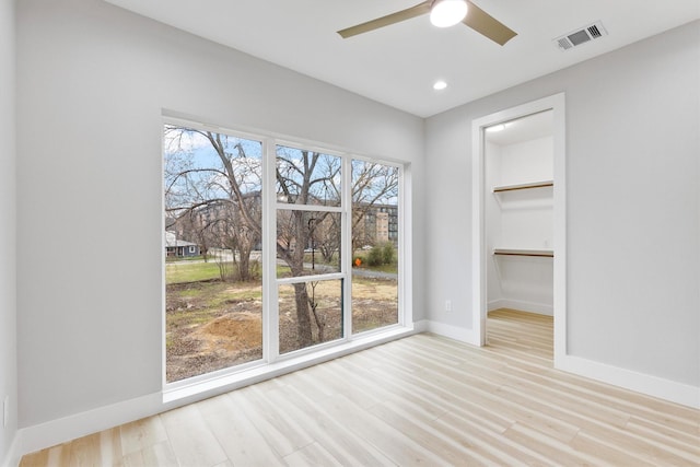 unfurnished dining area featuring light hardwood / wood-style flooring and ceiling fan