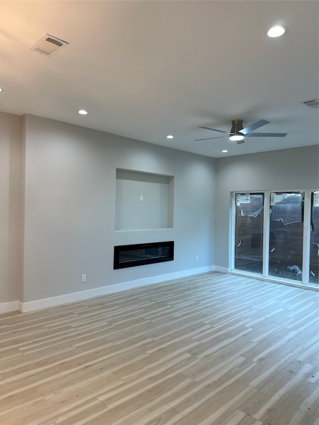 unfurnished living room with ceiling fan and light hardwood / wood-style floors