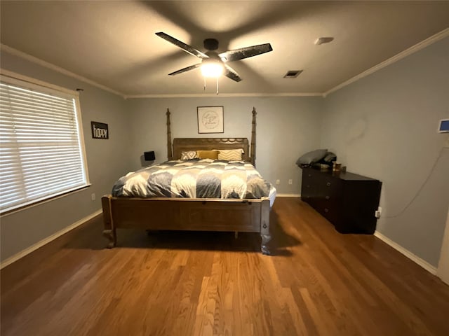 bedroom with dark wood-type flooring, ornamental molding, and ceiling fan