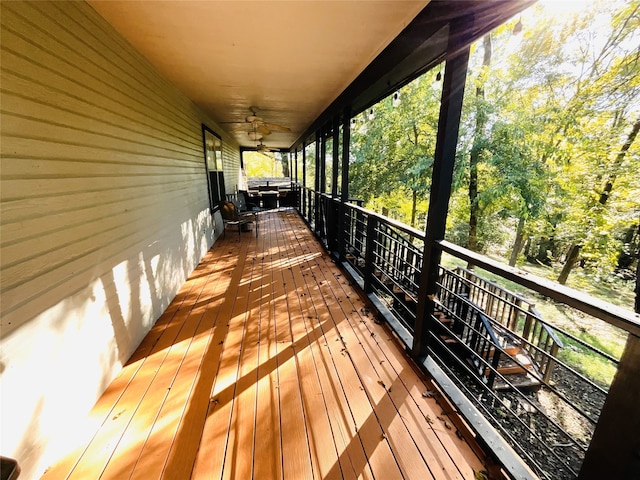 wooden terrace featuring ceiling fan