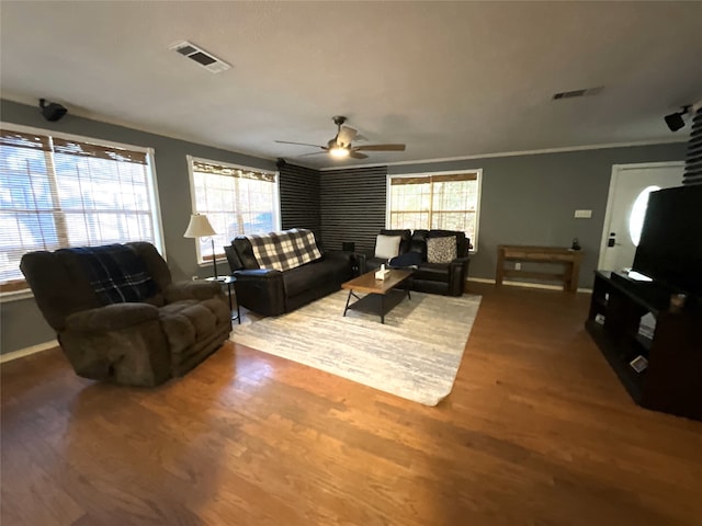 living room featuring hardwood / wood-style floors, ornamental molding, and ceiling fan