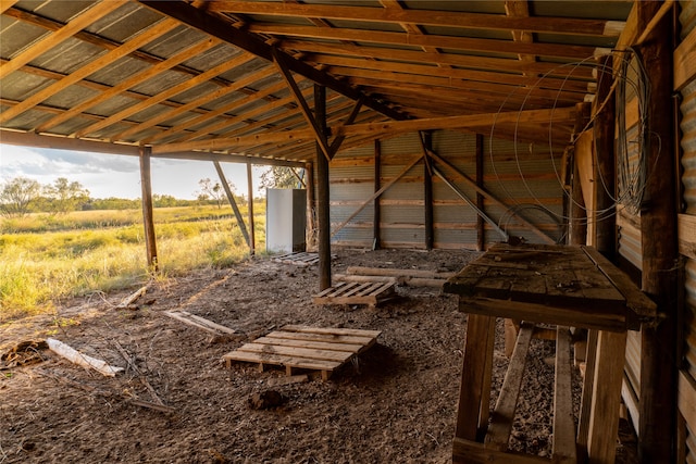 interior space featuring vaulted ceiling and a rural view