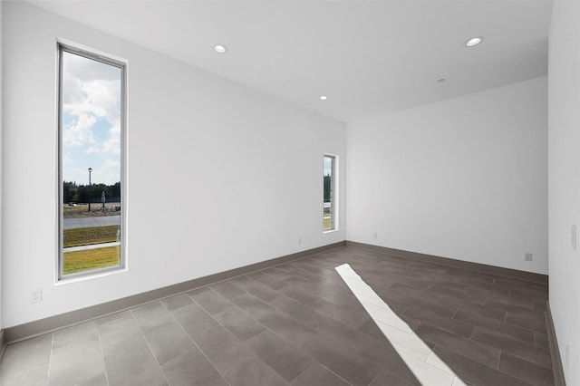 unfurnished room with dark wood-type flooring and a healthy amount of sunlight