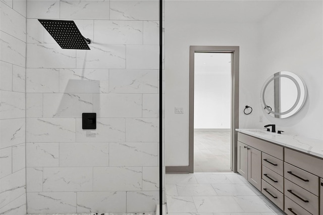 bathroom with vanity and tiled shower