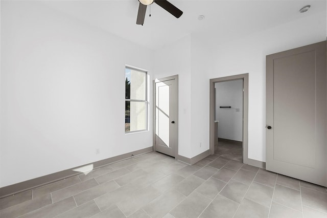 unfurnished bedroom with ceiling fan, a closet, and light tile patterned floors