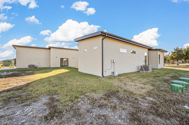 view of home's exterior with central AC and a lawn