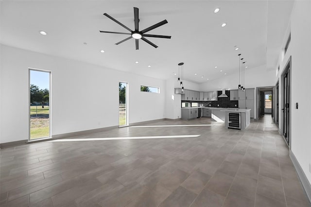 unfurnished living room featuring ceiling fan and wine cooler