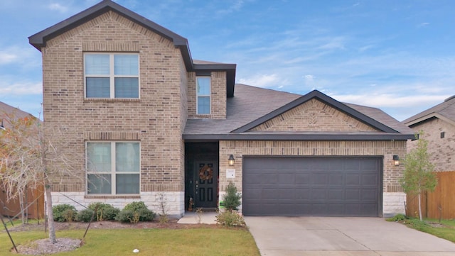 view of front of home with a garage and a front lawn