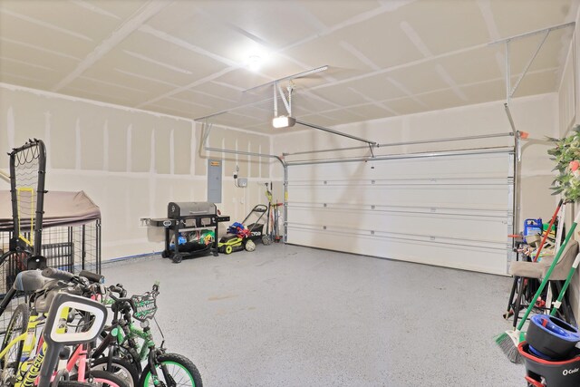 garage with electric panel and a garage door opener