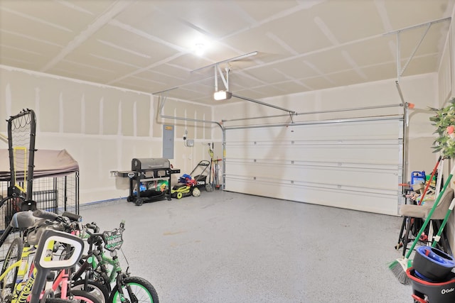 garage with a garage door opener and electric panel