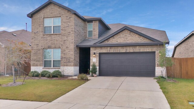 view of front of house with a front yard and a garage