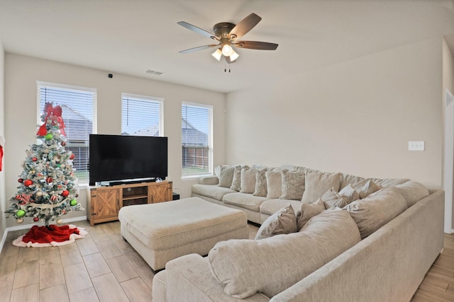 living room featuring light hardwood / wood-style floors and ceiling fan