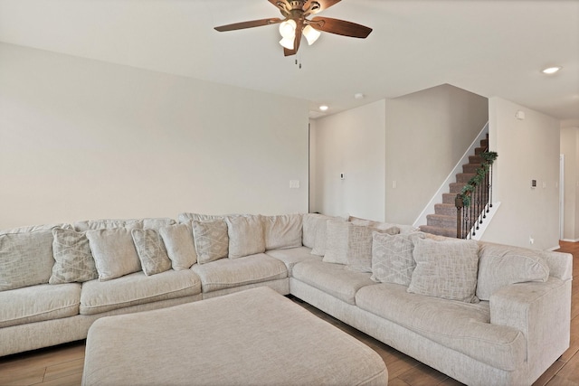 living room with hardwood / wood-style flooring and ceiling fan