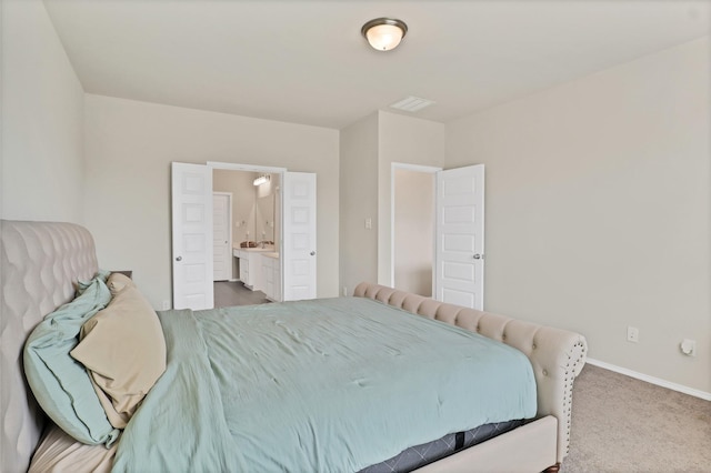 carpeted bedroom featuring connected bathroom