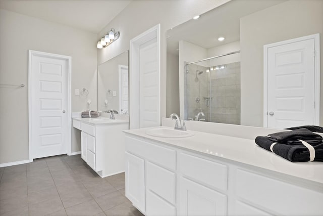 bathroom featuring tile patterned flooring, vanity, and a shower with door