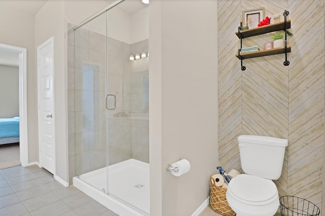 bathroom with toilet, tile patterned floors, and an enclosed shower