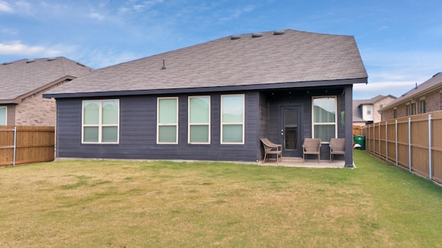 back of house featuring a lawn and a patio area