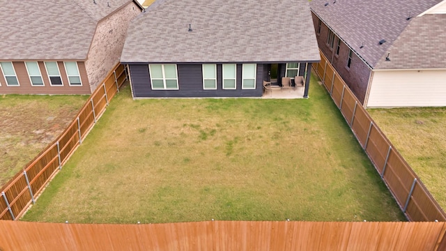 back of property featuring a patio area and a lawn