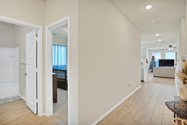 hallway with light wood-type flooring