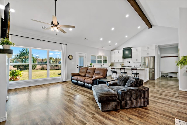 living room featuring sink, ceiling fan, beam ceiling, high vaulted ceiling, and light hardwood / wood-style floors