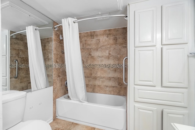 bathroom featuring tile patterned flooring, shower / bath combination with curtain, and toilet