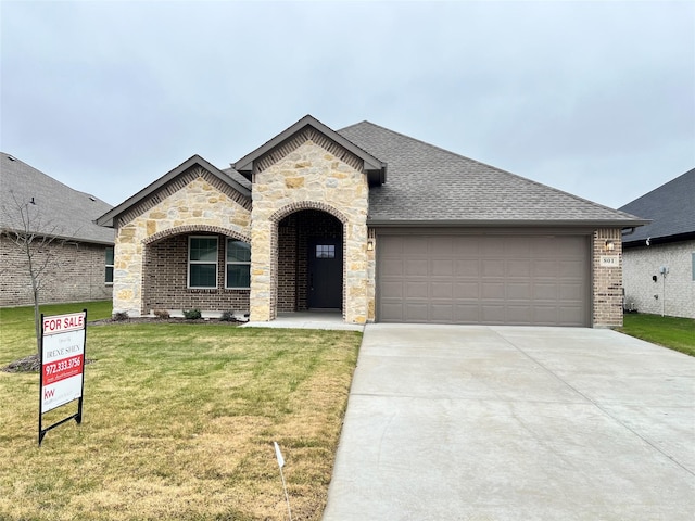 french country inspired facade featuring a front lawn and a garage