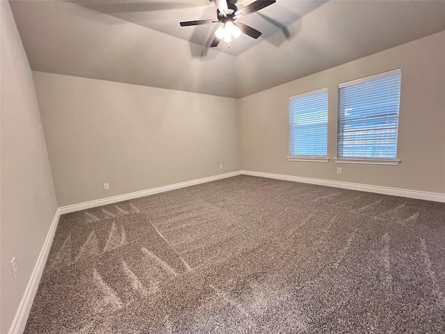 carpeted empty room with vaulted ceiling and ceiling fan