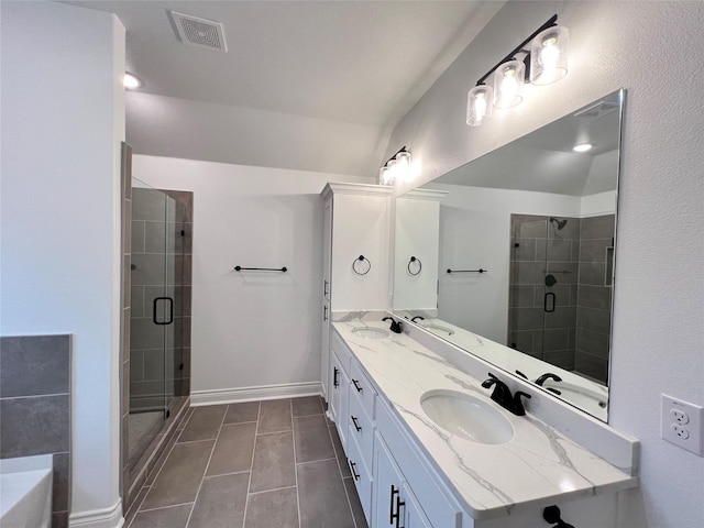 bathroom featuring vanity, tile patterned floors, and a shower with door