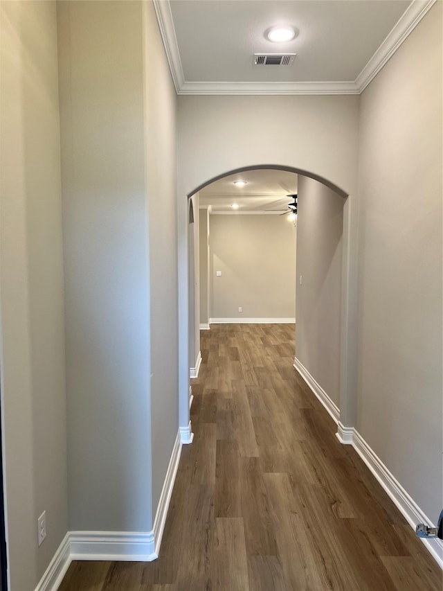 hallway featuring wood-type flooring and ornamental molding