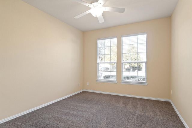 carpeted spare room with ceiling fan