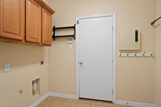 laundry room featuring hookup for an electric dryer, light tile patterned floors, hookup for a gas dryer, and cabinets