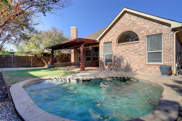 view of swimming pool featuring a yard and a patio