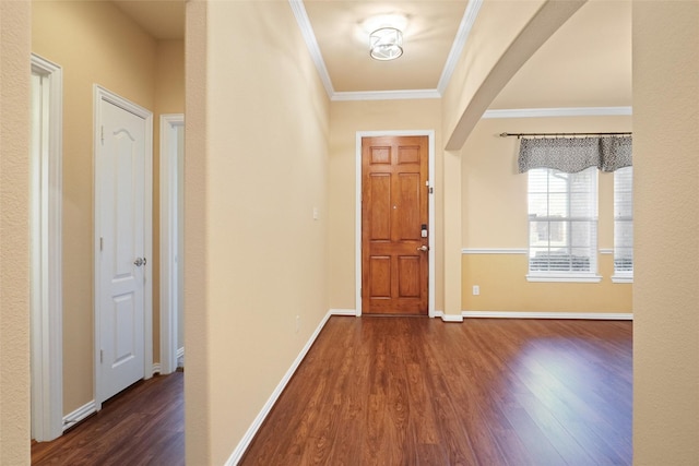 entryway with dark hardwood / wood-style floors and crown molding