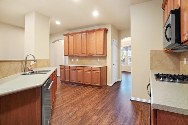 kitchen featuring decorative backsplash, sink, stainless steel appliances, and dark hardwood / wood-style floors