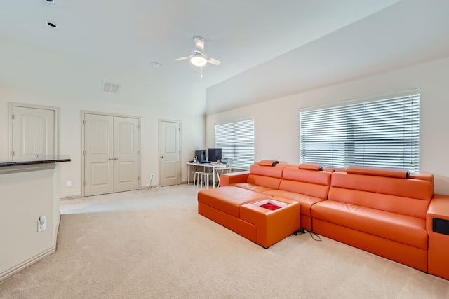 carpeted living room featuring ceiling fan and vaulted ceiling