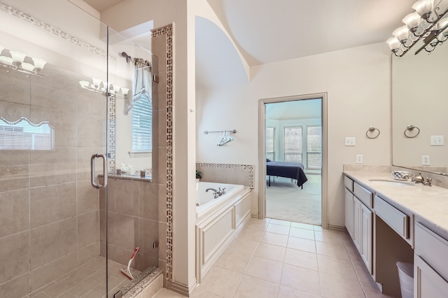 bathroom featuring plus walk in shower, vanity, and tile patterned floors