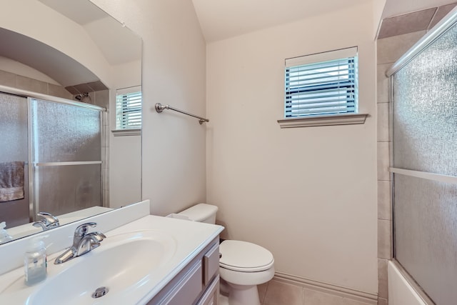 full bathroom with toilet, vanity, tile patterned floors, and a healthy amount of sunlight