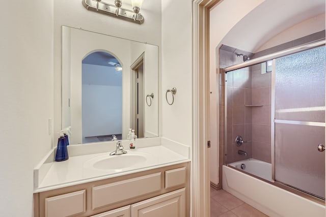 bathroom with tile patterned floors, vanity, ceiling fan, and enclosed tub / shower combo