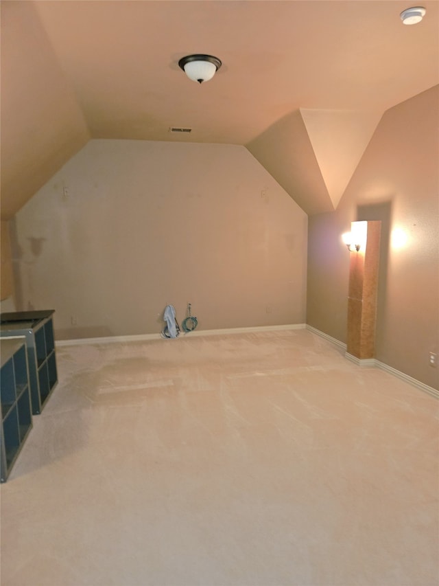 bonus room featuring carpet and vaulted ceiling