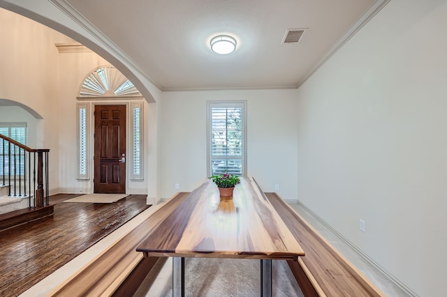 unfurnished dining area with crown molding, hardwood / wood-style floors, and a healthy amount of sunlight