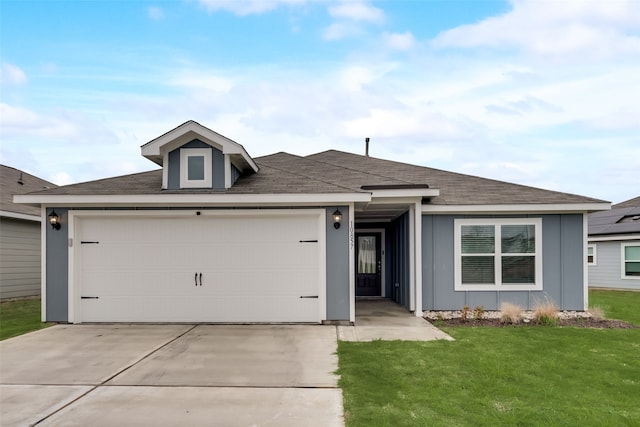 ranch-style house featuring a garage and a front lawn