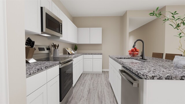 kitchen featuring white cabinetry, stainless steel appliances, sink, and light hardwood / wood-style flooring