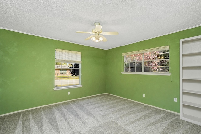 spare room featuring a textured ceiling, carpet floors, and ceiling fan