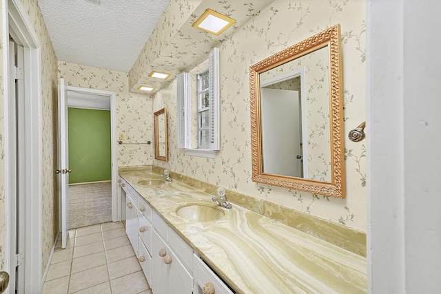 bathroom with vanity, tile patterned flooring, and a textured ceiling