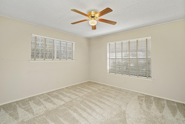 carpeted empty room featuring ceiling fan and a textured ceiling