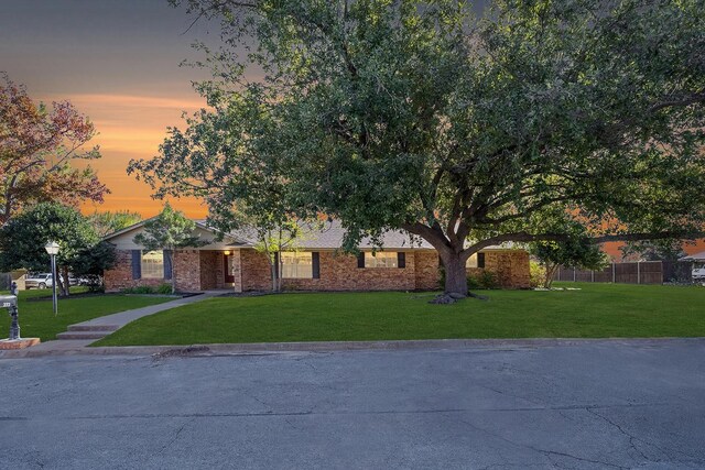 ranch-style home with a front lawn