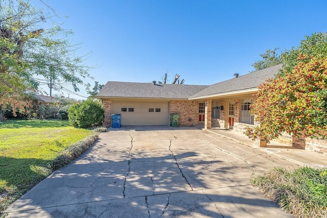 ranch-style house with a garage and a front yard