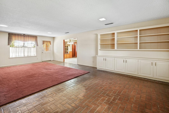 interior space with a textured ceiling