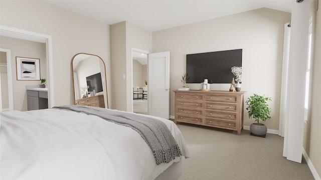 carpeted bedroom featuring ensuite bath